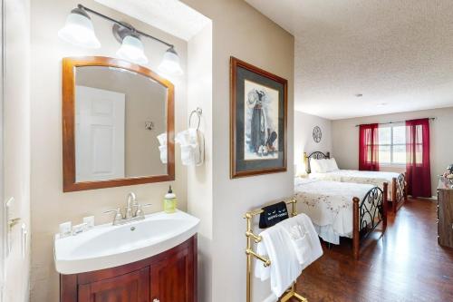 a bathroom with a sink and a bedroom with a bed at 116 Lake Club Dr, #12 Branson MO in Branson