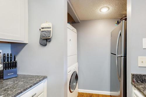 a kitchen with a washer and dryer next to a refrigerator at 116 Lake Club Dr, #12 Branson MO in Branson