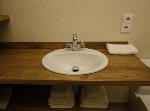 a white sink in a bathroom with a towel at CA L'HERBOLARI - Cozy house in Montseny in Viladrau