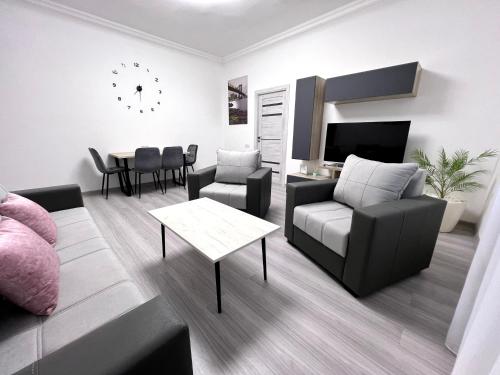a living room with a couch and a table at Luxe Apartment Komitas in Yerevan