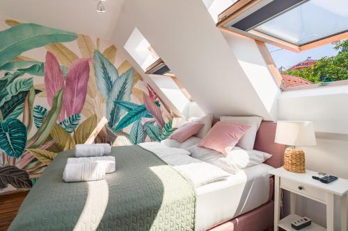 a bedroom with a bed with a tropical wallpaper at Monbuhim Twin in Veszprém