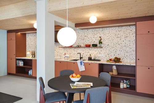 a kitchen and dining room with a table and chairs at Engelwirt Hotel & Apartments in Berching