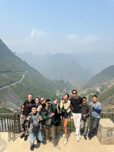 a group of people standing on top of a mountain at Strawberry House , Tour & Motorbikes Rentel in Ha Giang