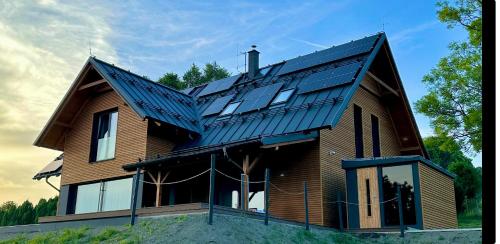 a house with solar panels on top of it at Chalupa Jestřabí in Jestrabi V Krkonosich