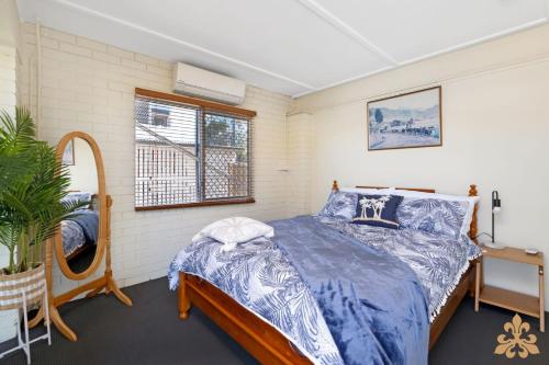 Un dormitorio con una cama y una ventana en Oasis On Rice Street Downstairs, en Rockhampton