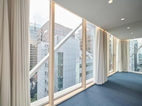a room with large windows in a building at UH Suite The Gangnam in Seoul