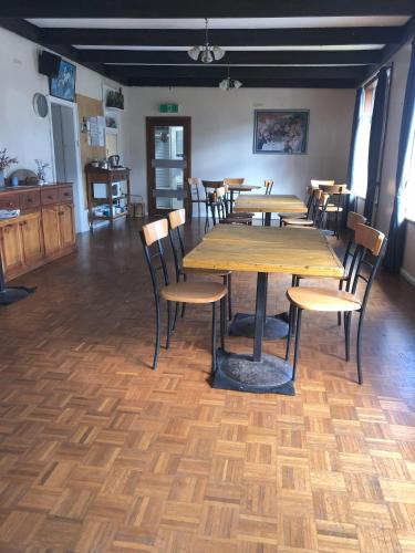 a dining room with wooden tables and chairs at Yarrabin Retreat in OʼConnell