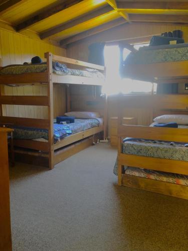 a room with three bunk beds in a cabin at Yarrabin Country Retreat in OʼConnell