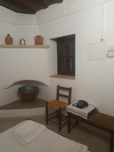 a room with a table and a chair and a stove at Ivi's House Giolou in Paphos City