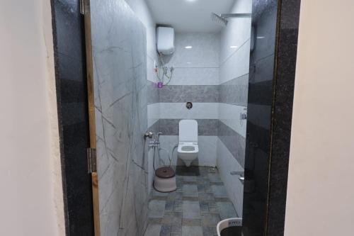 a small bathroom with a toilet and a sink at Hari Home Stay in Garudeshwar