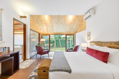 una camera da letto con un letto grande e un soggiorno di Villa De Exotica - Vesta Collections a Hoi An