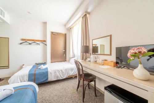 Una cama o camas en una habitación de Plaza In Miyakojima hotel