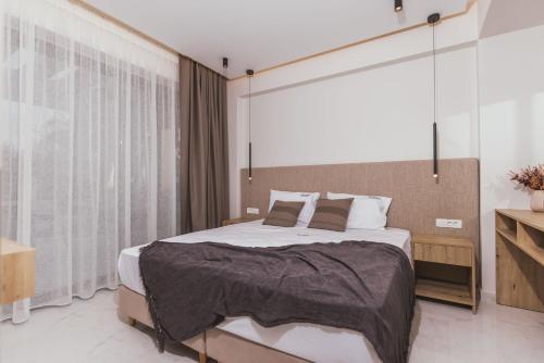 a bedroom with a large bed and a large window at Infinity Holiday Villas - Private Pool, close to Kalamaki Centre, by ZanteWize in Kalamaki