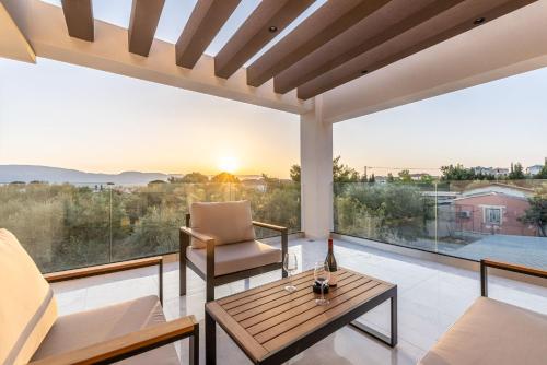 a living room with a couch and a table at Infinity Holiday Villas - Private Pool, close to Kalamaki Centre, by ZanteWize in Kalamaki