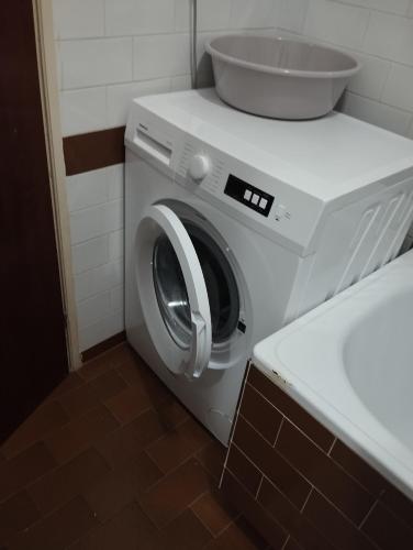 a washing machine in a bathroom next to a sink at Jasna1 in Knin