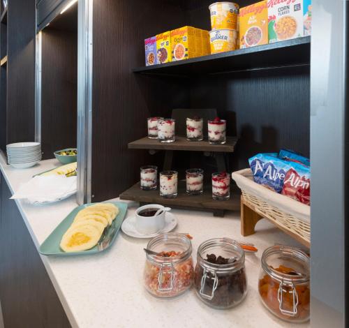 a kitchen with food in jars on a counter at Best Western Chiswick Palace & Suites London in London