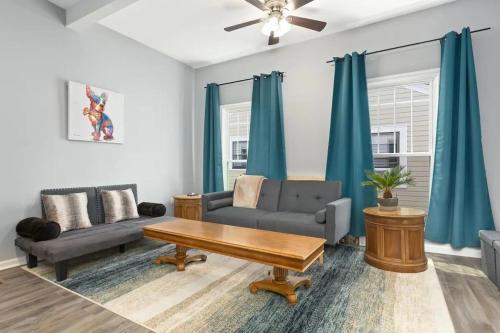 a living room with a couch and a table at Recently Renovated Chic Durham Farmhouse in Durham