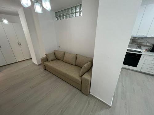 a living room with a couch in the corner at Lumiver Apartment in Golem