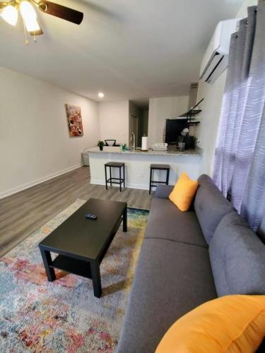 a living room with a couch and a table at LakewoodLyon Park Renovated Cottage Near Duke 26A in Durham