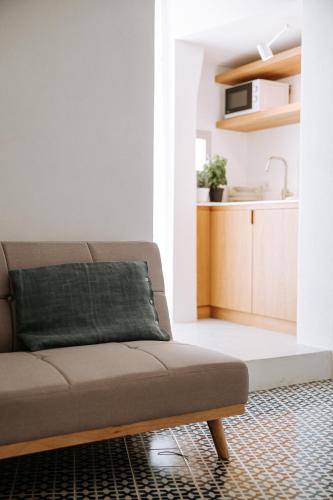 a living room with a couch and a kitchen at Infinito Bianco in Polignano a Mare