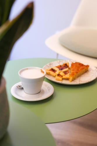 a plate of pizza and a cup of coffee on a table at Hotel L'Aretino in Arezzo