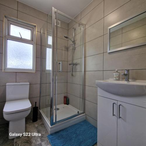 a bathroom with a shower and a toilet and a sink at 5 Bed Plymouth Home-Free Parking - Close to City Centre in Plymouth