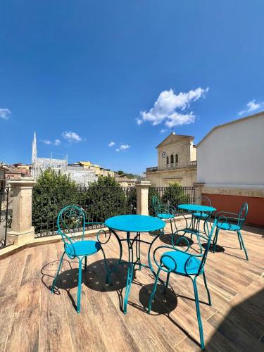 a group of tables and chairs on a roof at Dimore Hyblon in Cassaro