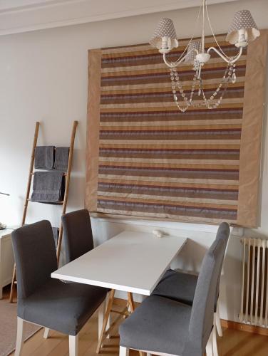 a dining room with a white table and chairs at Tiny Little SUITE in Athens