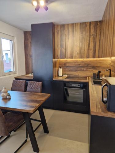 a kitchen with a table and a stove top oven at Maris i Maksim in Tribunj
