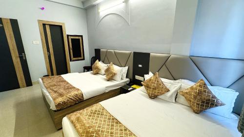 a hotel room with two beds and aception at Hotel City Palace in Varanasi