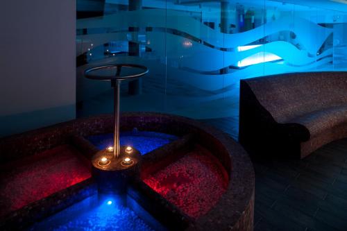 a room with a tub with a candle in it at Hotel Štekl in Hluboká nad Vltavou
