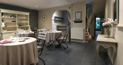 a restaurant with tables and chairs in a room at Hotel Saint Yves in Nantes