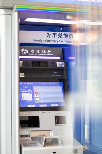 an atm machine with a display in a room at Huaqiang Plaza Hotel Shenzhen, Enjoy Complimentary Mini Bar & Night Snack, Add breakfast - enjoy complimentary afternoon tea in Shenzhen