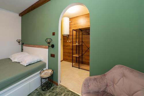 a bedroom with a bed and a door leading to a hallway at Бунгало Есмералда in Aheloy