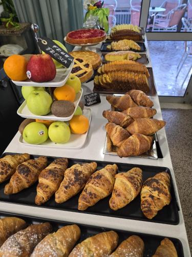 a buffet filled with different types of bread and pastries at Hotel Nanni Garnì in Rimini