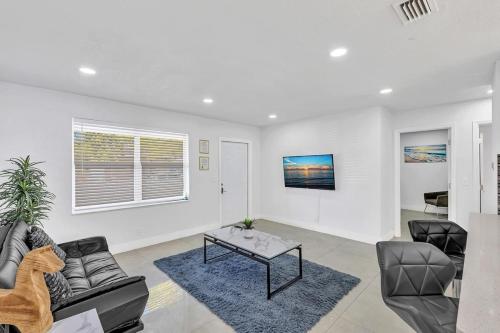 a living room with a couch and a table at 2 Bdrm Modern House Mins From Beach & Casino Hb1 in Hallandale Beach