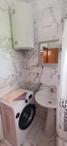 a washing machine in a bathroom with a sink at Adrovic in Bar, Susanj