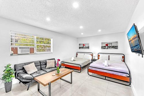 a living room with two beds and a couch at New 2 Bed Studio Close To Beach & Casino Ha04 in Hollywood