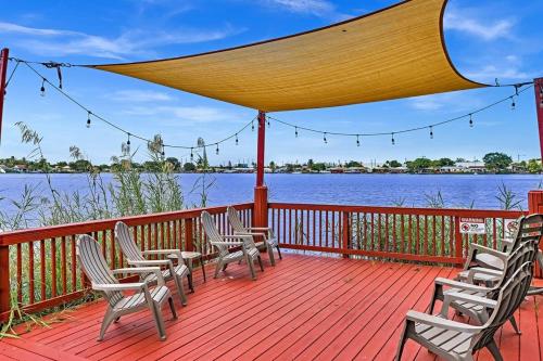 a deck with chairs and a view of the water at Beautiful Cozy Lakefront HomeCasinoAirportBeach in Fort Lauderdale