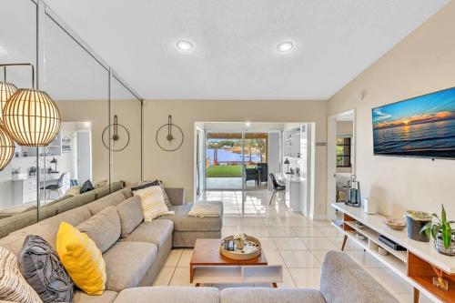 a living room with a couch and a table at Beautiful Cozy Lakefront HomeCasinoAirportBeach in Fort Lauderdale