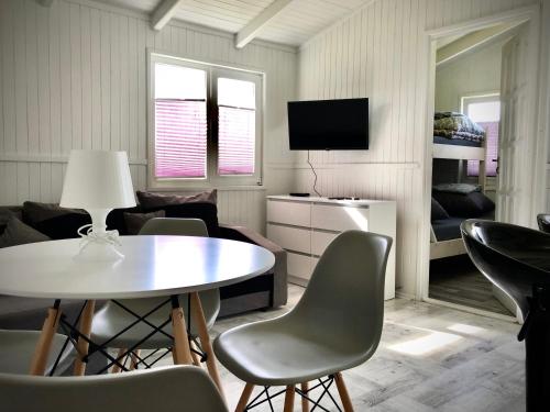 a living room with a table and chairs at Domki SILVER 3 in Jarosławiec