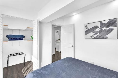 a bedroom with white walls and a bed in a room at Two Bedroom Hollywood Beach Vacation Sc01 in Hollywood