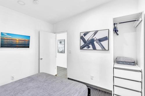 a bedroom with a bed and some pictures on the wall at Two Bedroom Hollywood Beach Vacation Sc01 in Hollywood