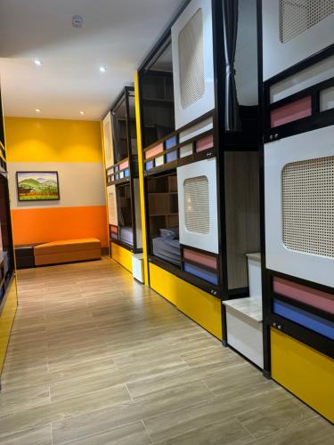 a room with yellow and orange walls and a hallway at Ha Giang Hostel in Ha Giang