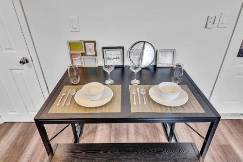 a table with plates and wine glasses on it at Hallandale Mins From Beach & Aventura Mall Hn01 in Hallandale Beach