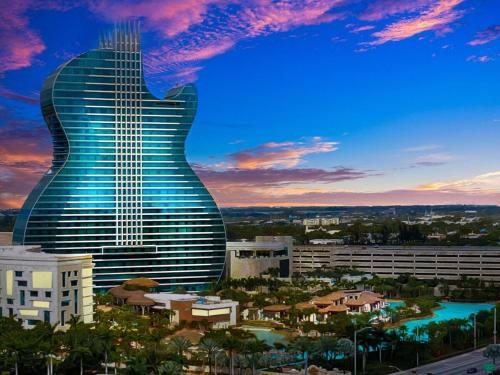 a guitar shaped building with a city in the background at Boutique One Bdrm Close To Aventura Mall & Beach in Hallandale Beach