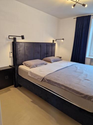 a bedroom with a large bed with a wooden headboard at Maris i Maksim in Tribunj