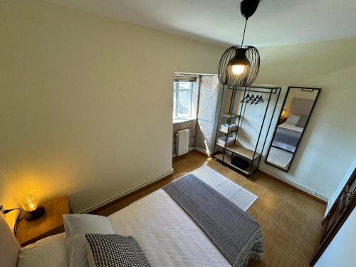 a bedroom with a bed and a mirror in it at Casa de Mucha in Camariñas