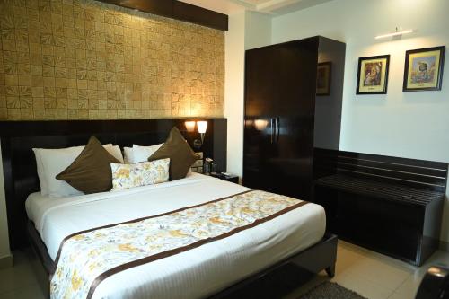 a bedroom with a large bed and a piano at The Vaishnavi in Deoghar