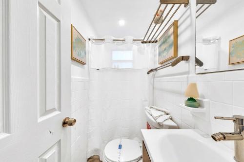 a white bathroom with a toilet and a sink at Hollywood 2 Bdrm Beach Vacation & Hard Rock Sc02 in Hollywood